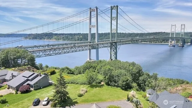 a view of a lake with a bridge and a building in the background