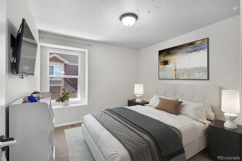 a bedroom with a balcony a bed and a flat screen tv