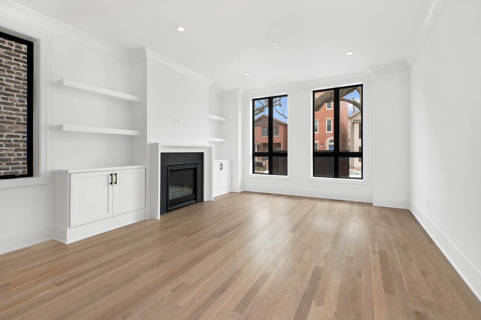 2051 North Racine Avenue, Unit 1 Chicago, IL 60614 - Photo 2 of 21 a view of an empty room with wooden floor fireplace and a window