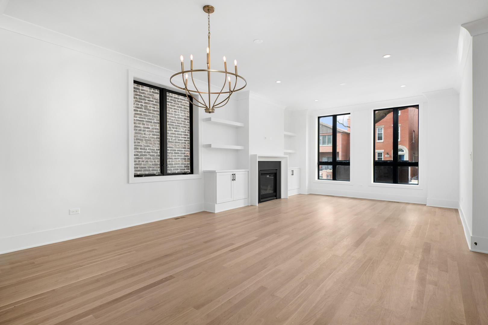 2051 North Racine Avenue, Unit 1 Chicago, IL 60614 - Photo 3 of 21 a view of empty room with wooden floor and kitchen