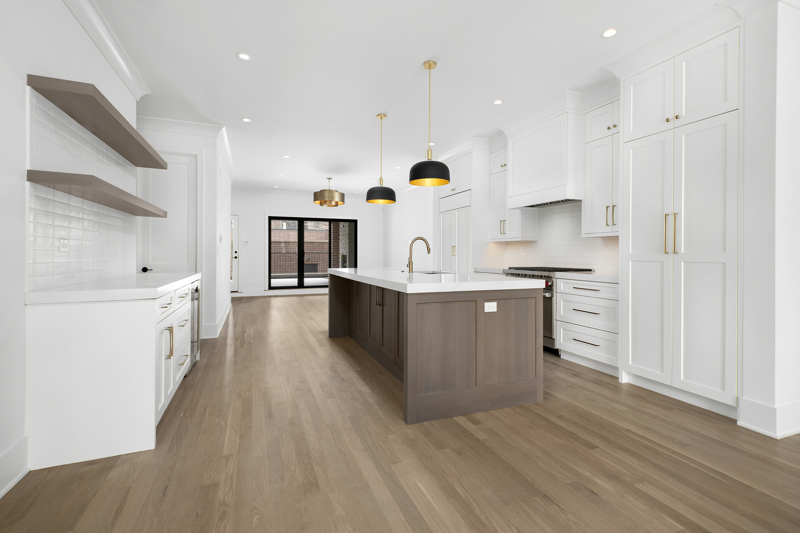 2051 North Racine Avenue, Unit 1 Chicago, IL 60614 - Photo 5 of 21 a large white kitchen with wooden floors and stainless steel appliances