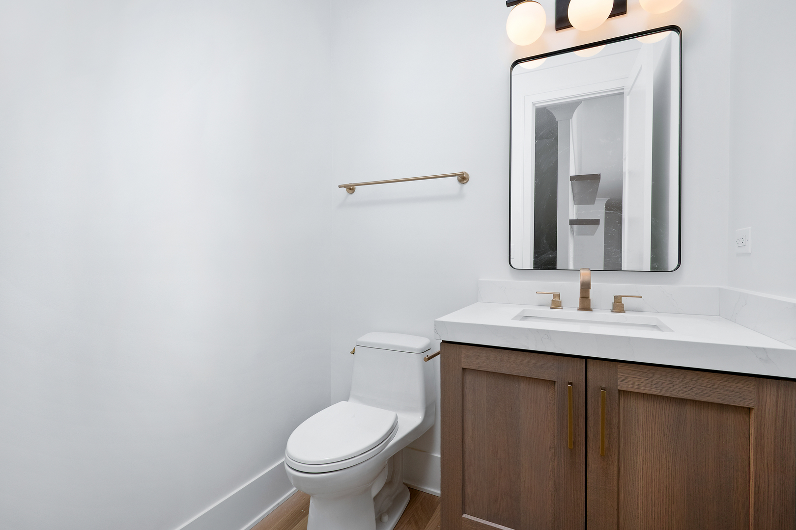 2051 North Racine Avenue, Unit 1 Chicago, IL 60614 - Photo 9 of 21 a bathroom with a toilet sink and mirror