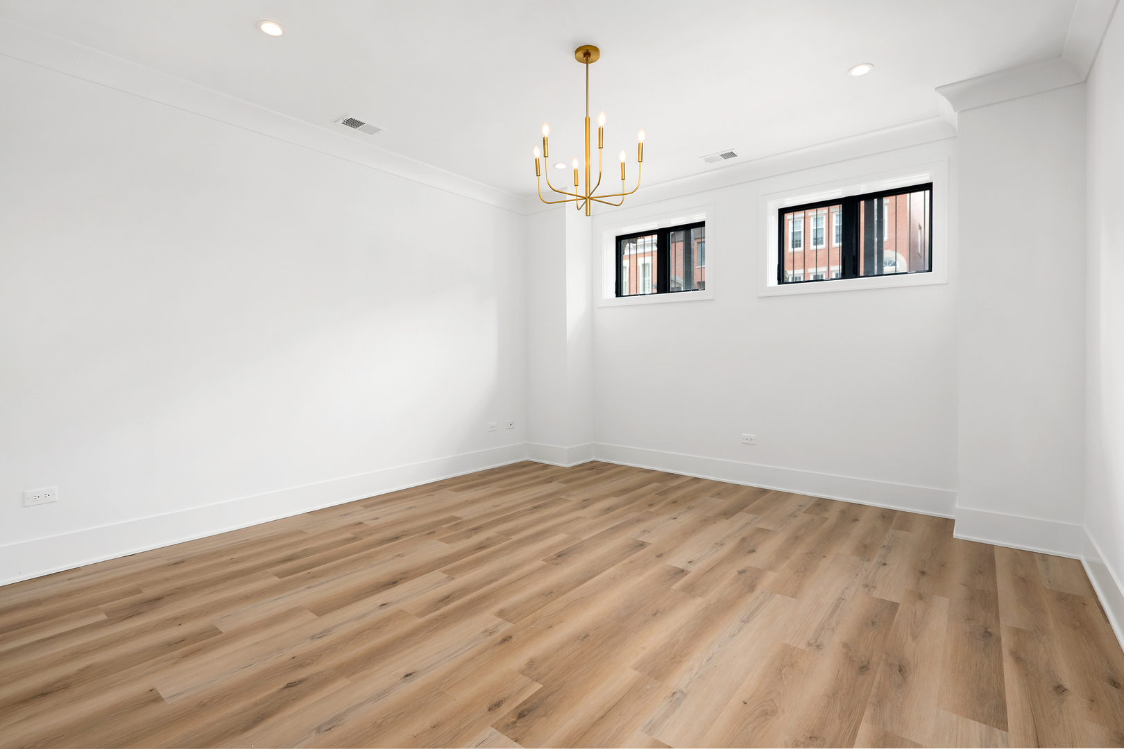 2051 North Racine Avenue, Unit 1 Chicago, IL 60614 - Photo 10 of 21 a view of an empty room with wooden floor and a window