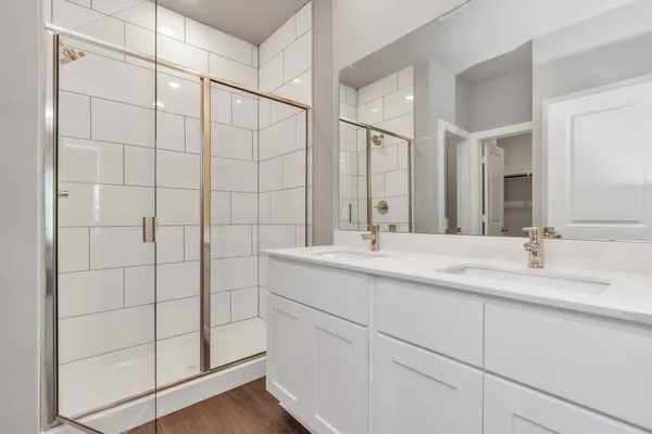 a bathroom with a double vanity sink and mirror