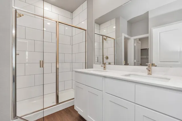 a bathroom with a double vanity sink and mirror