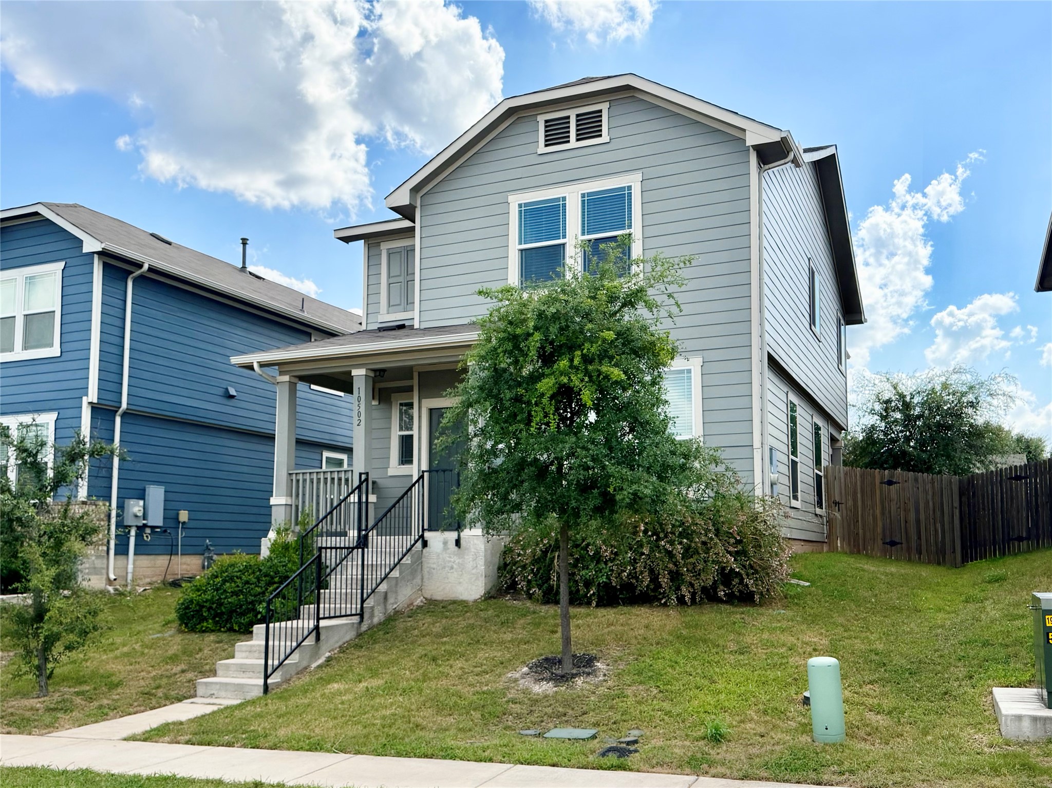10502 Fulton Avenue Austin, TX 78754 - Photo 2 of 36 A welcoming front porch leads to this charming two-story residence with a neatly manicured lawn.