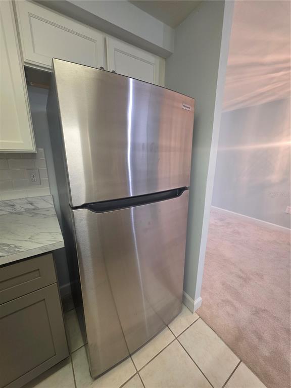 4461 Rustic Drive, Unit 4461 New Port Richey, FL 34652 - Photo 12 of 34 a view of a refrigerator with wooden floor