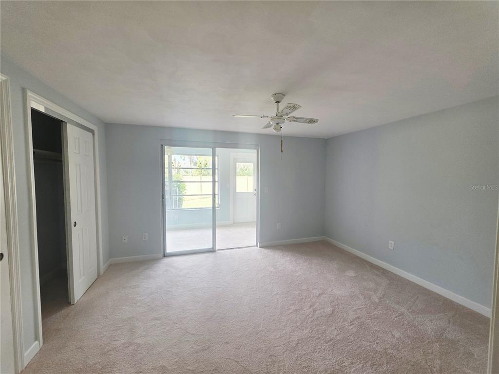 4461 Rustic Drive, Unit 4461 New Port Richey, FL 34652 - Photo 14 of 34 a view of an empty room with a chandelier fan