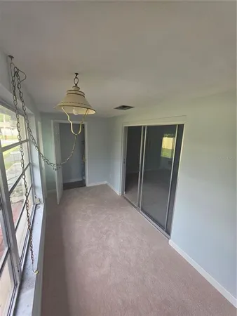 a view of a hallway with wooden floor and stairs