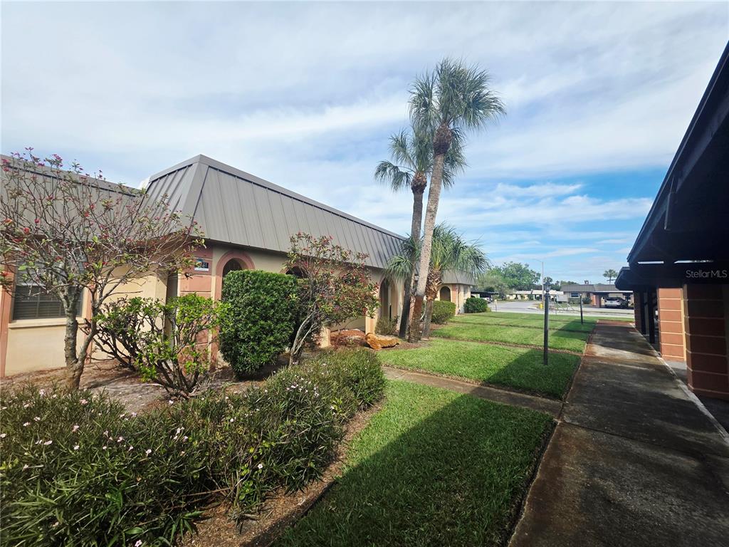 4461 Rustic Drive, Unit 4461 New Port Richey, FL 34652 - Photo 2 of 34 a view of a garden with a fountain