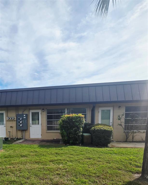 4461 Rustic Drive, Unit 4461 New Port Richey, FL 34652 - Photo 21 of 34 a view of a house with a yard and a large tree