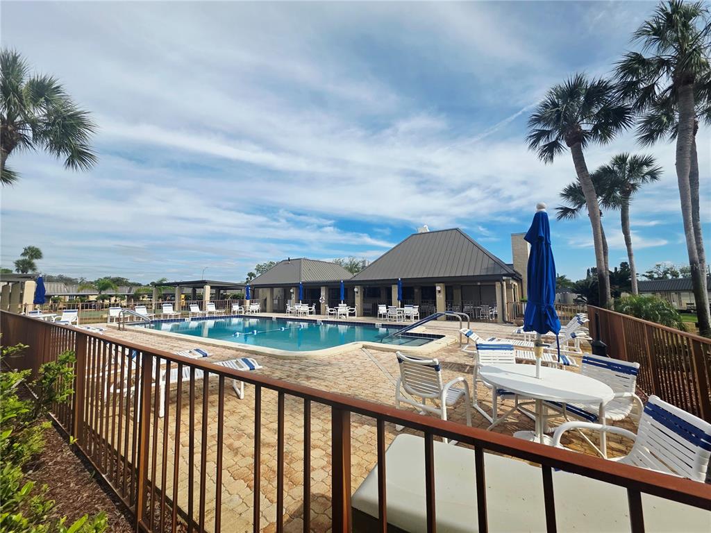 4461 Rustic Drive, Unit 4461 New Port Richey, FL 34652 - Photo 27 of 34 a view of a balcony with two chairs and a table