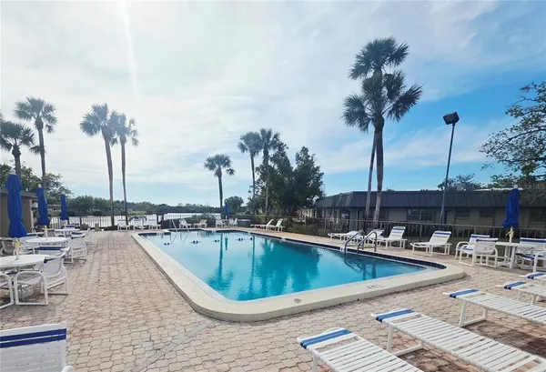 a swimming pool view with a outdoor seating space
