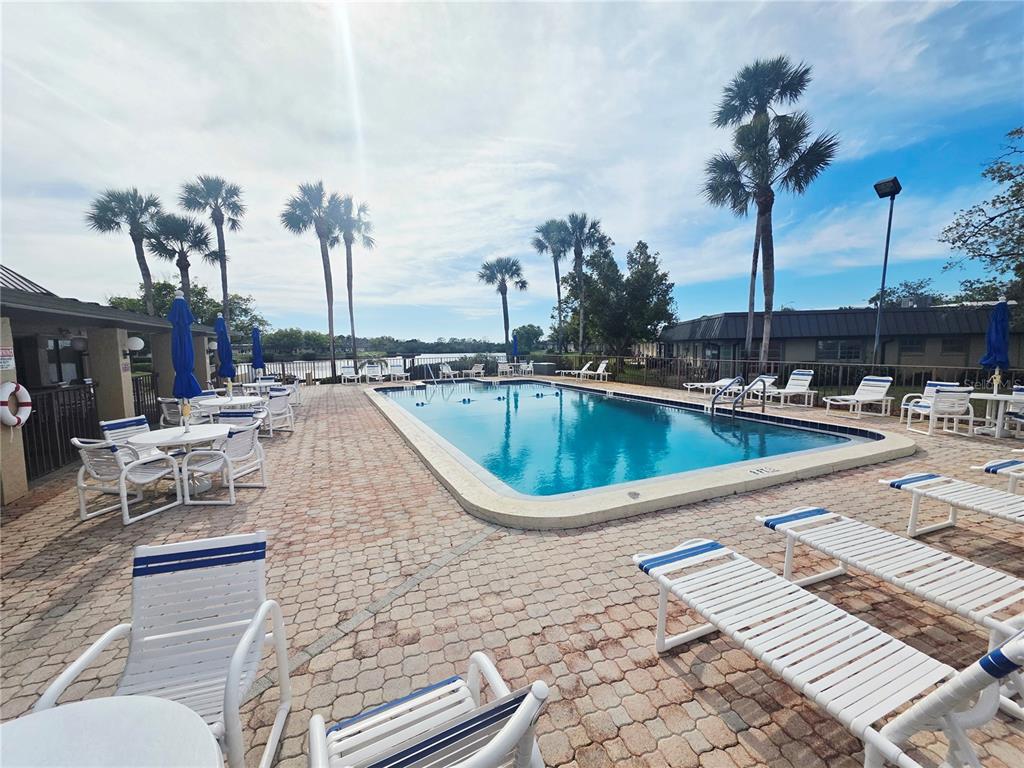4461 Rustic Drive, Unit 4461 New Port Richey, FL 34652 - Photo 30 of 34 a swimming pool view with a outdoor seating space