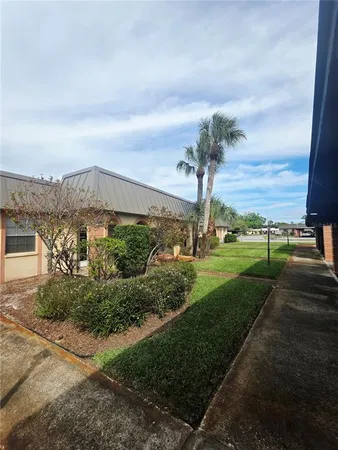 a view of a city street next to a building