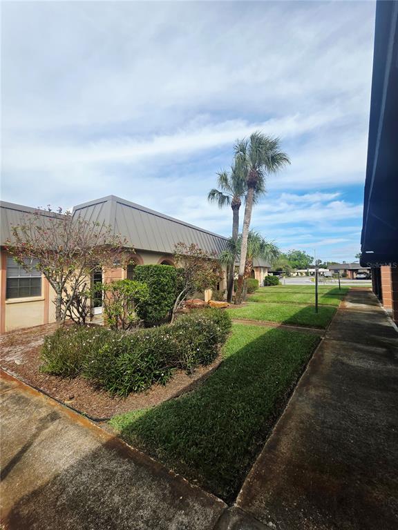 4461 Rustic Drive, Unit 4461 New Port Richey, FL 34652 - Photo 3 of 34 a view of a city street next to a building