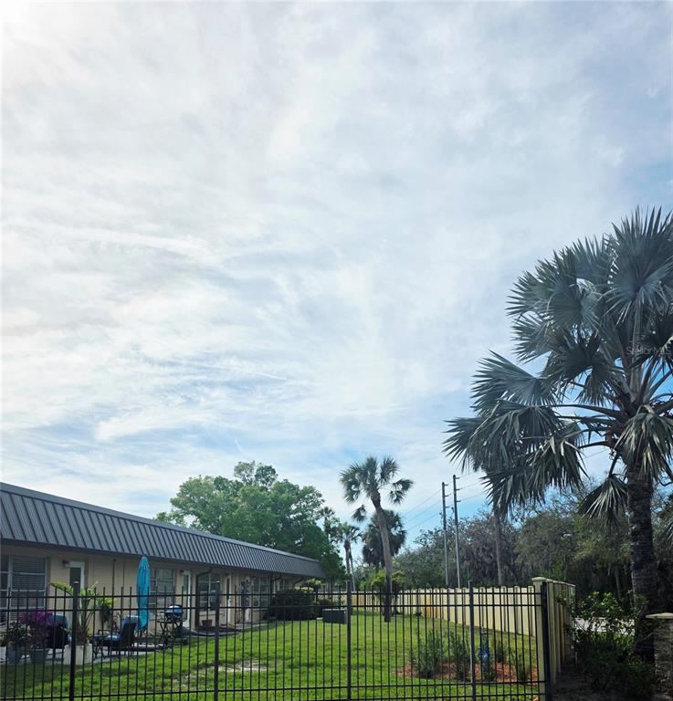 4461 Rustic Drive, Unit 4461 New Port Richey, FL 34652 - Photo 34 of 34 a view of a white house in a big yard with potted plants