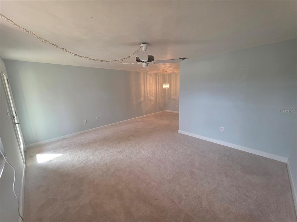 4461 Rustic Drive, Unit 4461 New Port Richey, FL 34652 - Photo 5 of 34 en empty room with windows and fan