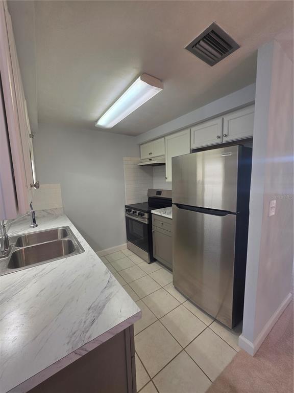 4461 Rustic Drive, Unit 4461 New Port Richey, FL 34652 - Photo 9 of 34 a kitchen with granite countertop a refrigerator and a sink