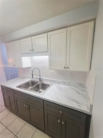 a stove top oven sitting inside of a kitchen