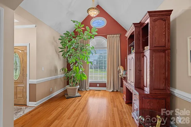 a view of an entryway with wooden floor and a potted plant