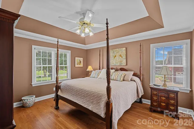 a bedroom with a large bed and a chandelier