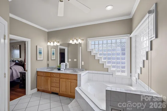 a bathroom with a tub sink and mirror