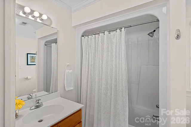 a bathroom with a sink vanity granite shower and a mirror