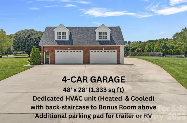 a sign on the side of a grassy field