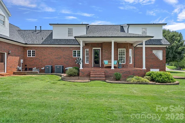 front view of a brick house with a yard