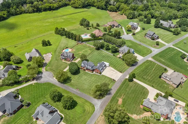 an aerial view of a residential houses with outdoor space and street view