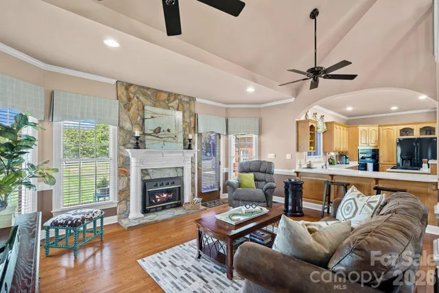 a living room with furniture fireplace and window