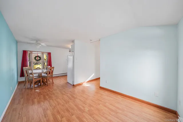 a view of a dining room with furniture and a large window