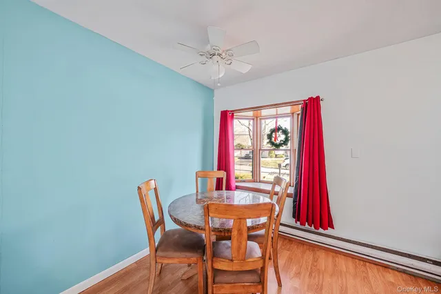 a kitchen with stainless steel appliances granite countertop a refrigerator a stove and white cabinets with wooden floor