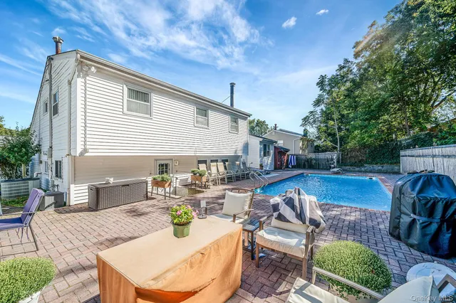 a view of a house with swimming pool and a yard