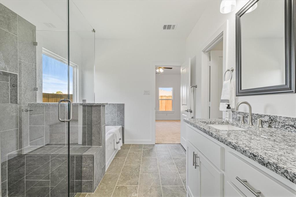 428 Cirrus Circle Muenster, TX 76252 - Photo 14 of 30 a bathroom with a granite countertop sink and a mirror