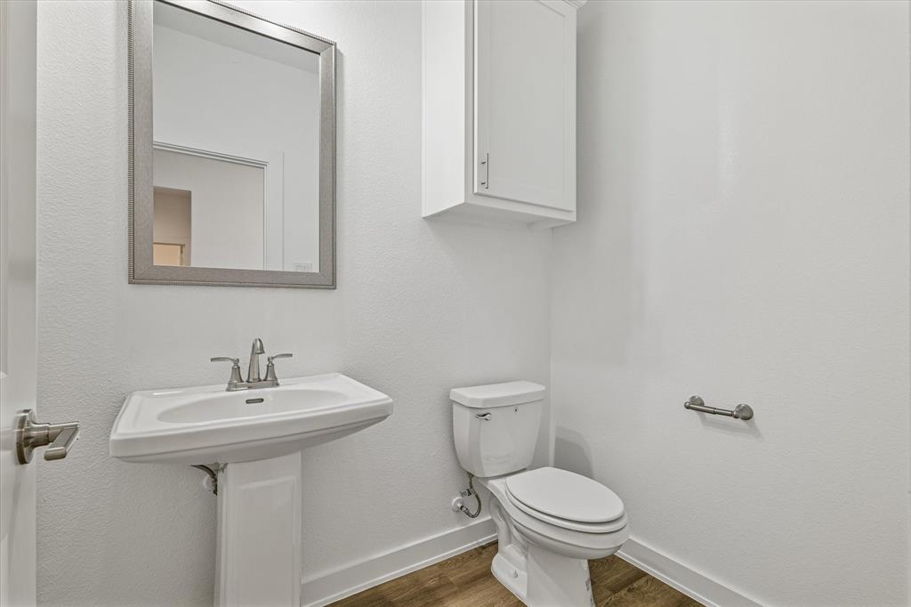 428 Cirrus Circle Muenster, TX 76252 - Photo 22 of 30 a bathroom with a toilet sink and mirror