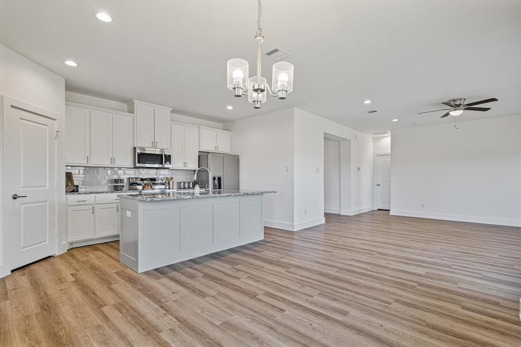 428 Cirrus Circle Muenster, TX 76252 - Photo 7 of 30 a view of a kitchen with stove and cabinets