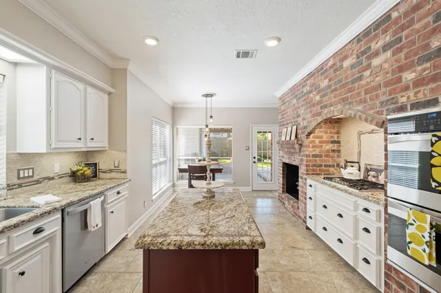 a large white kitchen with cabinets