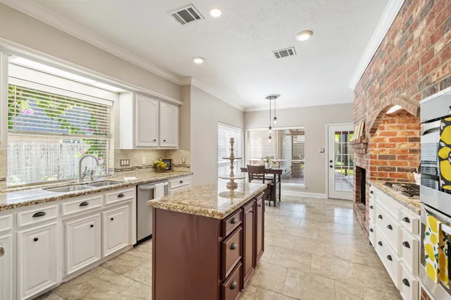 a large kitchen with kitchen island a sink counter space appliances and a window