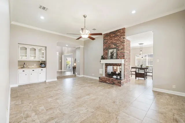 a view of livingroom with kitchen and chandelier