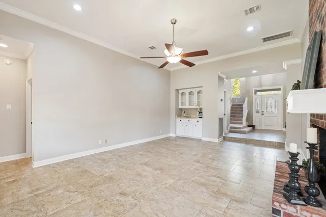 a view of an empty room with a kitchen