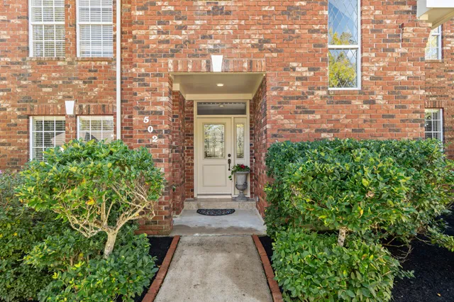 a view of a brick house with a large windows