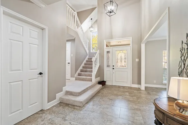 a view of a livingroom with wooden floor and staircase