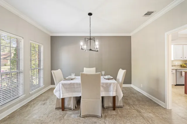 a view of a dining room with furniture wooden floor and chandelier