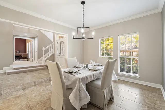 a view of a dining room with furniture wooden floor and chandelier