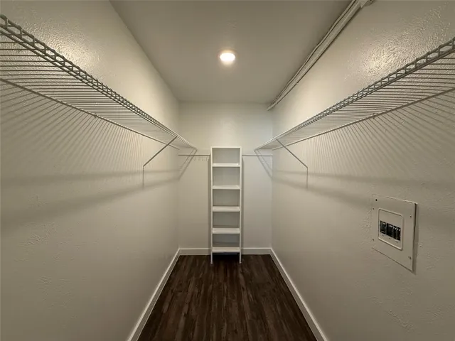 a view of a room with wooden floors and white walls