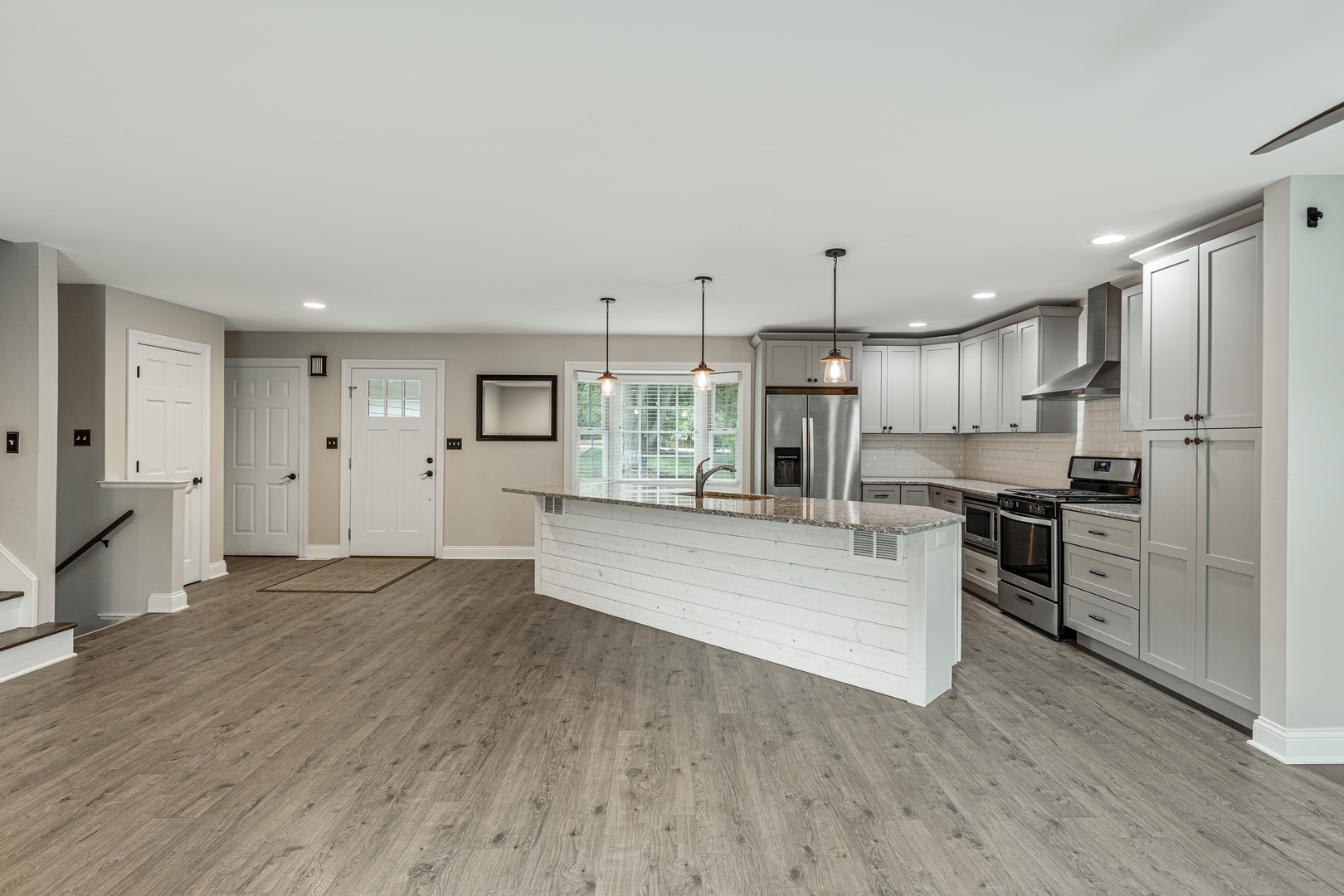 1N136 Pouley Road Elburn, IL 60119 - Photo 10 of 30 a large kitchen with stainless steel appliances kitchen island a large counter top and wooden floors