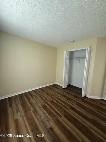 a view of an empty room and wooden floor