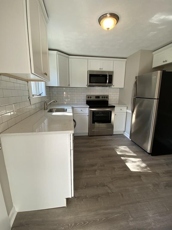 70 Plumtree Circle Springfield, MA 01118 - Photo 7 of 29 a kitchen with stainless steel appliances a refrigerator stove and microwave